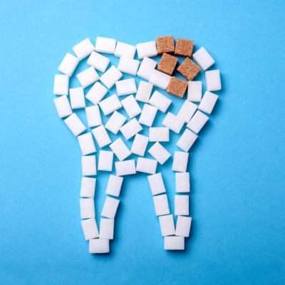 Sugar cubes arranged as a tooth, brown sugar decay