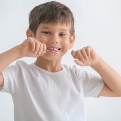 Young boy holding dental floss