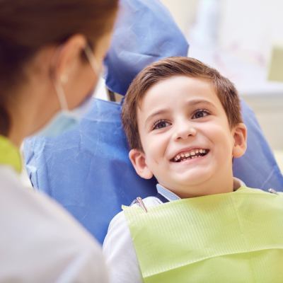 Young boy in dentist chair smiling