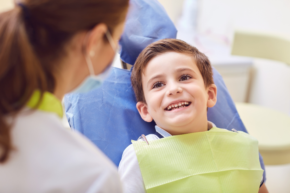 Young boy in dentist chair smiling
