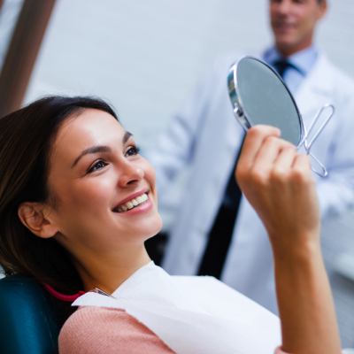 Patient looking in mirror and smiling