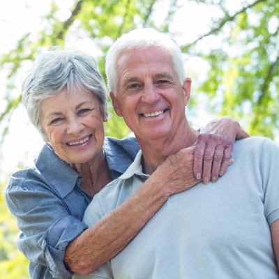 Older couple smiling in the park