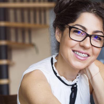 Adult woman smiling with braces