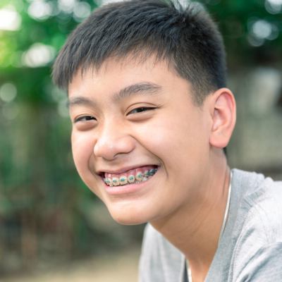 Young boy with braces smiling