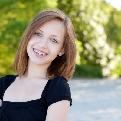 Young girl with braces smiling