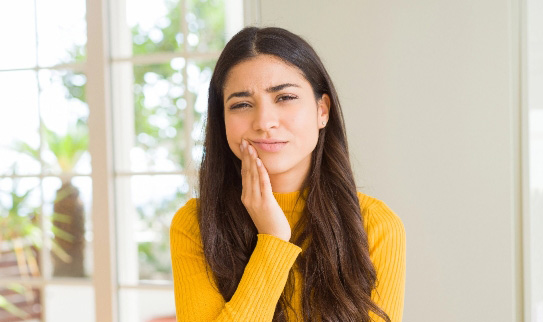 Young woman with jaw pain